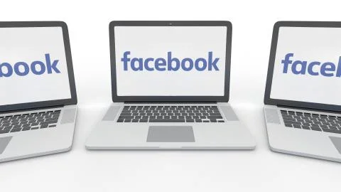 Notebooks with Facebook logo on the screen. Computer technology conceptual Stock Illustration