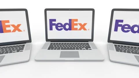 Notebooks with FedEx logo on the screen. Computer technology conceptual Stock Illustration