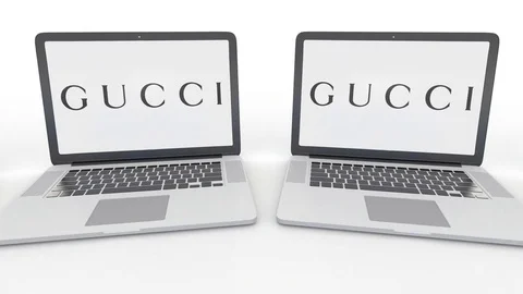 Notebooks with Gucci logo on the screen. Computer technology conceptual Stock Footage