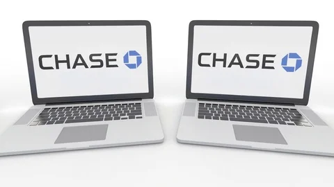 Notebooks with JPMorgan Chase Bank logo on the screen. Computer technology Stock Footage