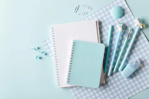 Notebooks with pens on a blue background. Back to school. Copy space. Flat la Stock Photos