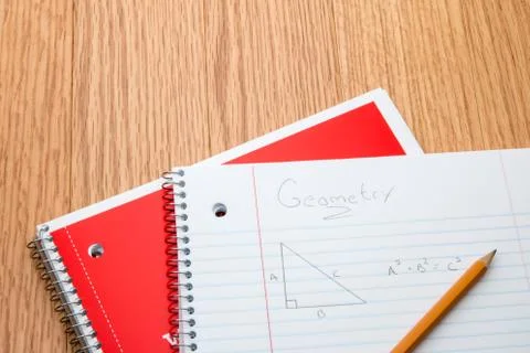 Notebooks on a school desk with geometry notes. Stock Photos