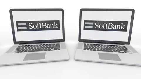 Notebooks with SoftBank logo on the screen. Computer technology conceptual Stock Footage
