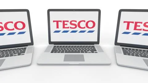 Notebooks with Tesco logo on the screen. Computer technology conceptual Stock-Illustration
