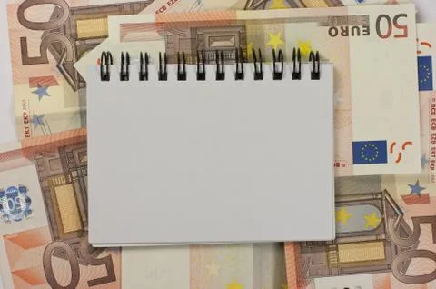 Notepad and banknotes Stock Photos