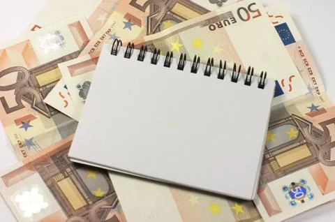 Notepad and banknotes Stock Photos