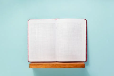 Notepad and book on shelf at wall background Stock Photos