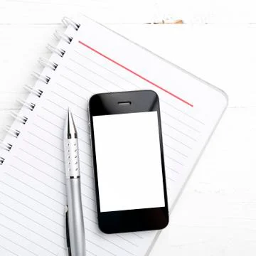 Notepad and cellphone Stock Photos