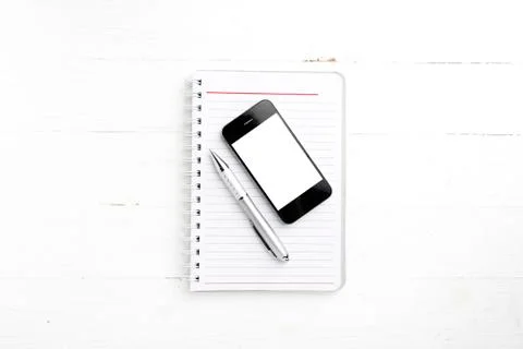 Notepad and cellphone Stock Photos