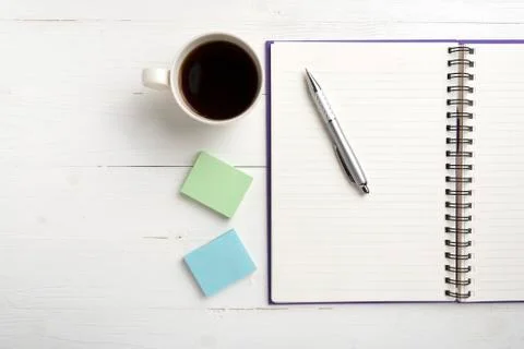 Notepad and coffee cup Stock Photos