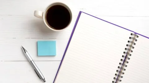 Notepad and coffee cup Stock Photos