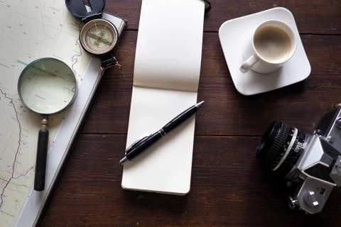 Notepad and coffee with map and compass Фото