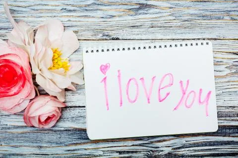 Notepad and flowers Stock Photos