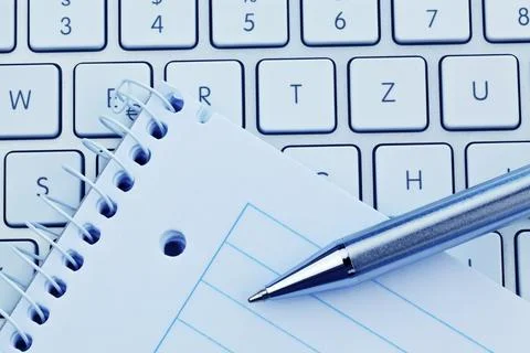 A notepad and the keyboard of a computer. Take notes and save them. Austria Stock Photos