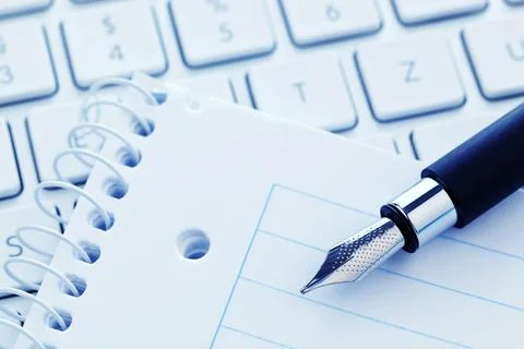 A notepad and the keyboard of a computer. Take notes and save them. Austria Stock Photos