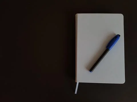 Notepad and pen on black isolated background Stock Photos
