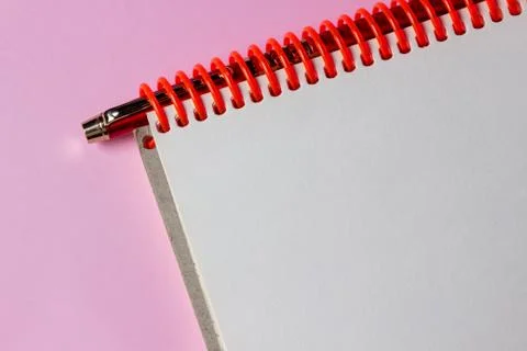 Notepad and pen on a pink background. A clean notepad.  Stock Photos