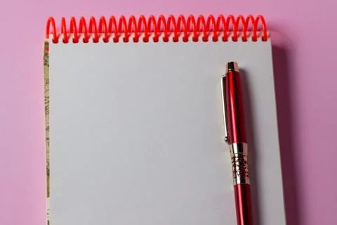 Notepad and pen on a pink background. A clean notepad.  Stock Photos