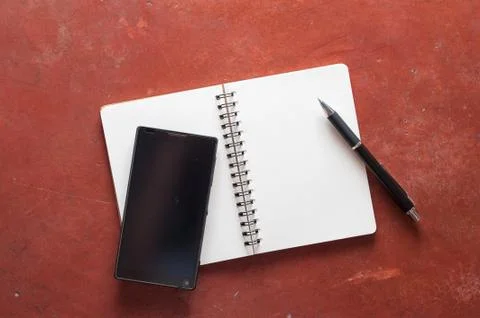 Notepad and smartphone Stock Photos