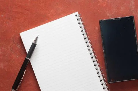 Notepad and smartphone Stock Photos