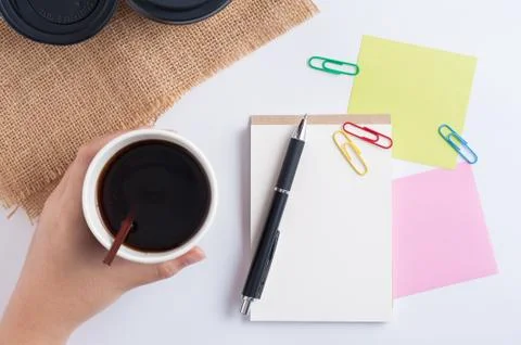 Notepad and take away coffee cup Stock Photos