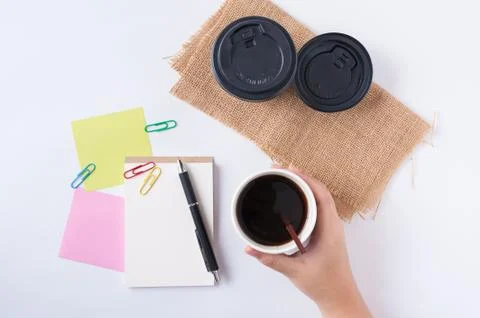 Notepad and take away coffee cup Stock Photos