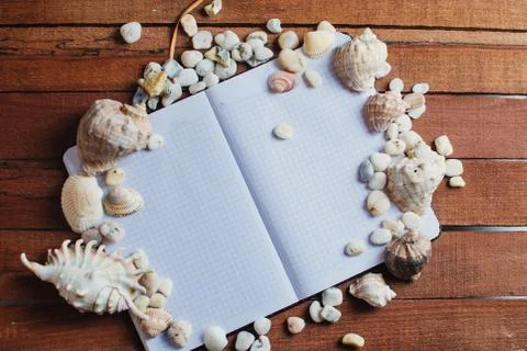Notepad around him shells Stock Photos