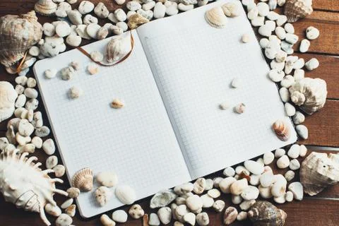 Notepad around him shells Stock Photos