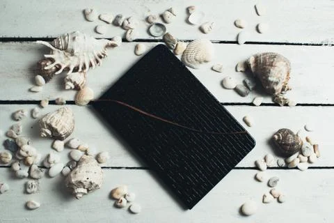 Notepad around him shells Stock Photos