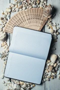 Notepad around him shells Stock Photos