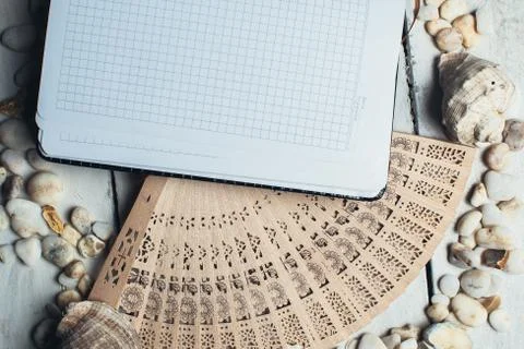 Notepad around him shells Stock Photos