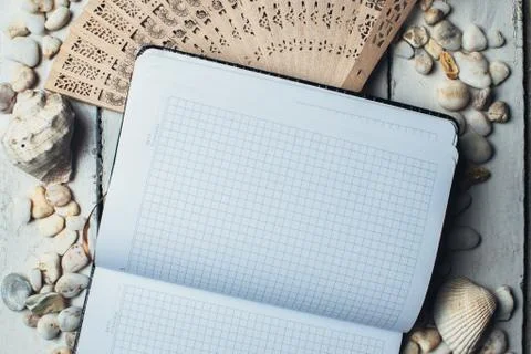 Notepad around him shells Stock Photos