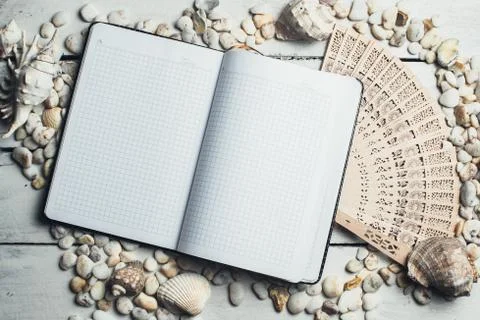 Notepad around him shells Stock Photos