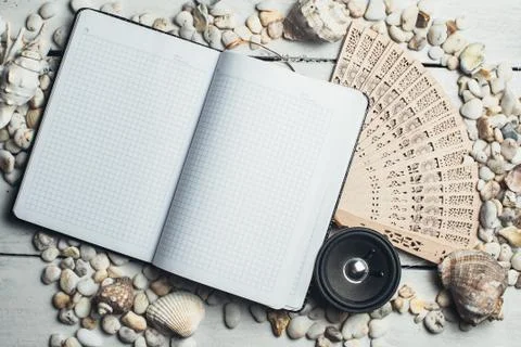 Notepad around him shells Stock Photos