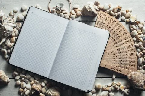 Notepad around him shells Stock Photos