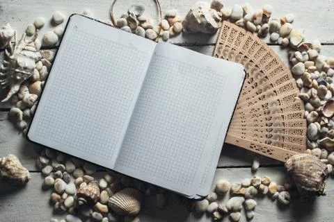 Notepad around him shells Stock Photos