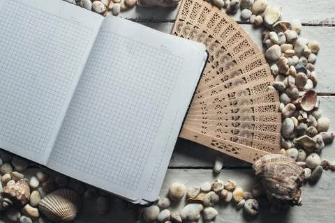 Notepad around him shells Stock Photos