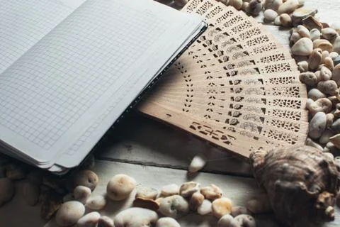 Notepad around him shells Stock Photos