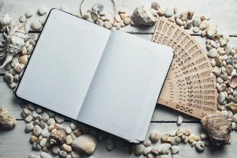 Notepad around him shells Stock Photos