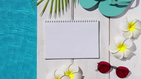 Notepad with beach items by the pool Video stock 201527910