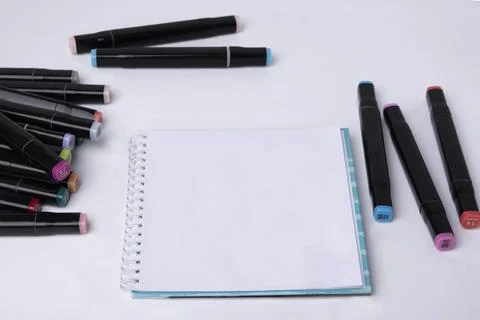 Notepad, blank sheet and phone on a white background. Top view. Stock Photos