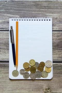 Notepad with a blank white sheet in a checker paper with russian coins and ba Foto stock