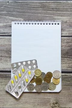 Notepad with a blank white sheet in a checker paper with russian coins and pi Stock Photos