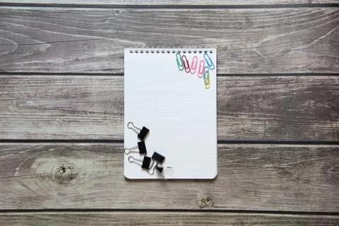 Notepad with a blank white sheet in a checker paper with a clip and with pape Stock Photos