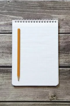 Notepad with a blank white sheet in a checker paper with simple graphite penc Stock Photos