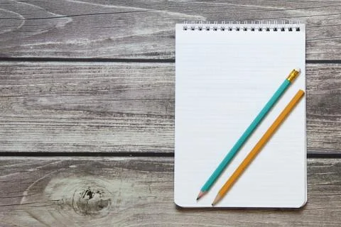 Notepad with a blank white sheet in a checker paper with simple graphite penc Stock Photos