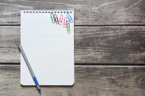 Notepad with a blank white sheet in a checker paper and with ball pen and wit Stock Photos