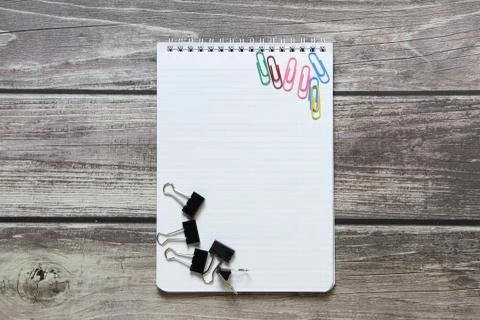 Notepad with a blank white sheet in a checker paper with a clip and with pape Stock Photos