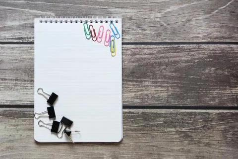 Notepad with a blank white sheet in a checker paper with a clip and with pape Stock Photos