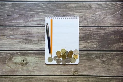 Notepad with a blank white sheet in a checker paper with russian coins and ba Stock Photos